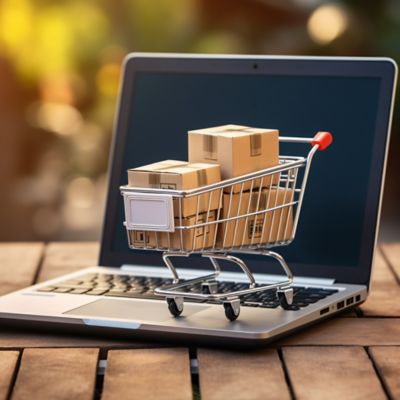  a tiny shopping cart filled with boxes sitting on laptop computer, UPtime | DXC Technology